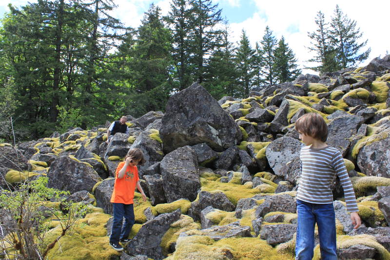 kids on mossy boulder slope