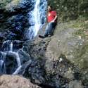 Me sitting by a waterfall